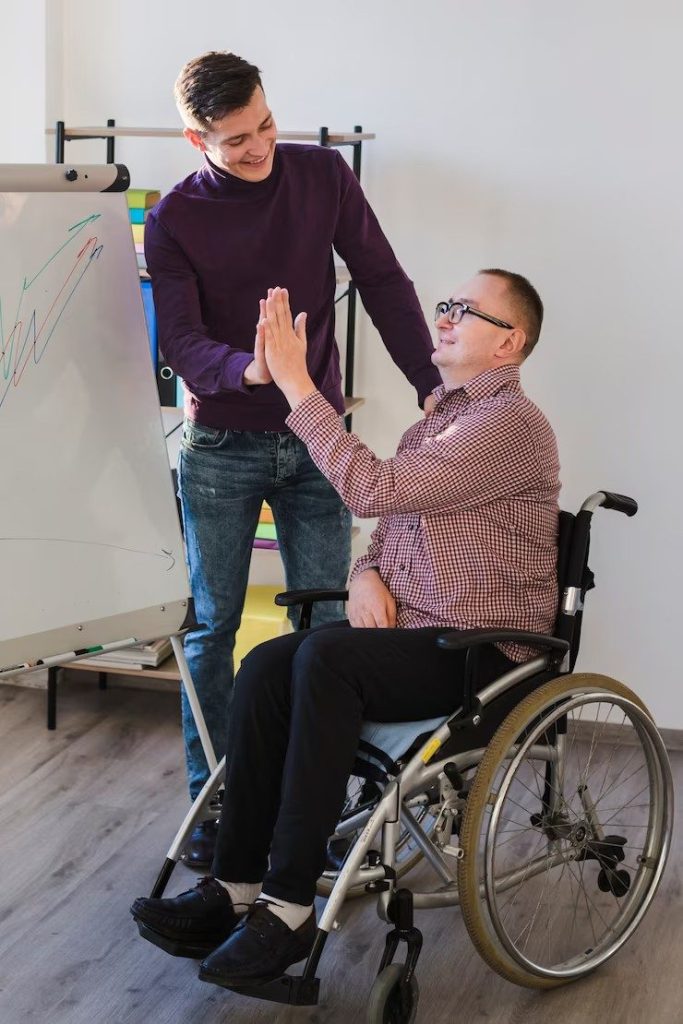 support worker helping man on wheelchair